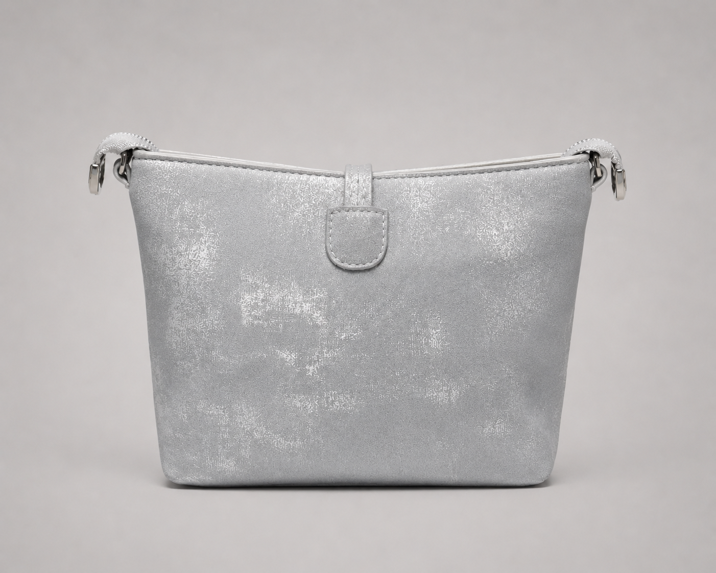 Back view of the same silver metallic shimmer bag showing a clean smooth panel with subtle textured finish, a small leather loop tab at the top center, and silver swivel-hook hardware connecting the braided rope shoulder strap on both sides.


